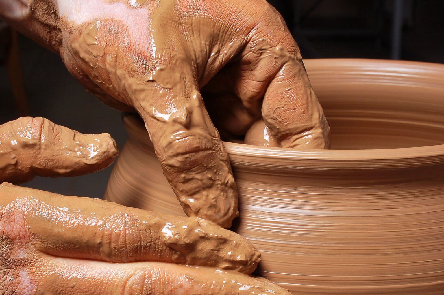 hands of a potter, creating an earthen jar